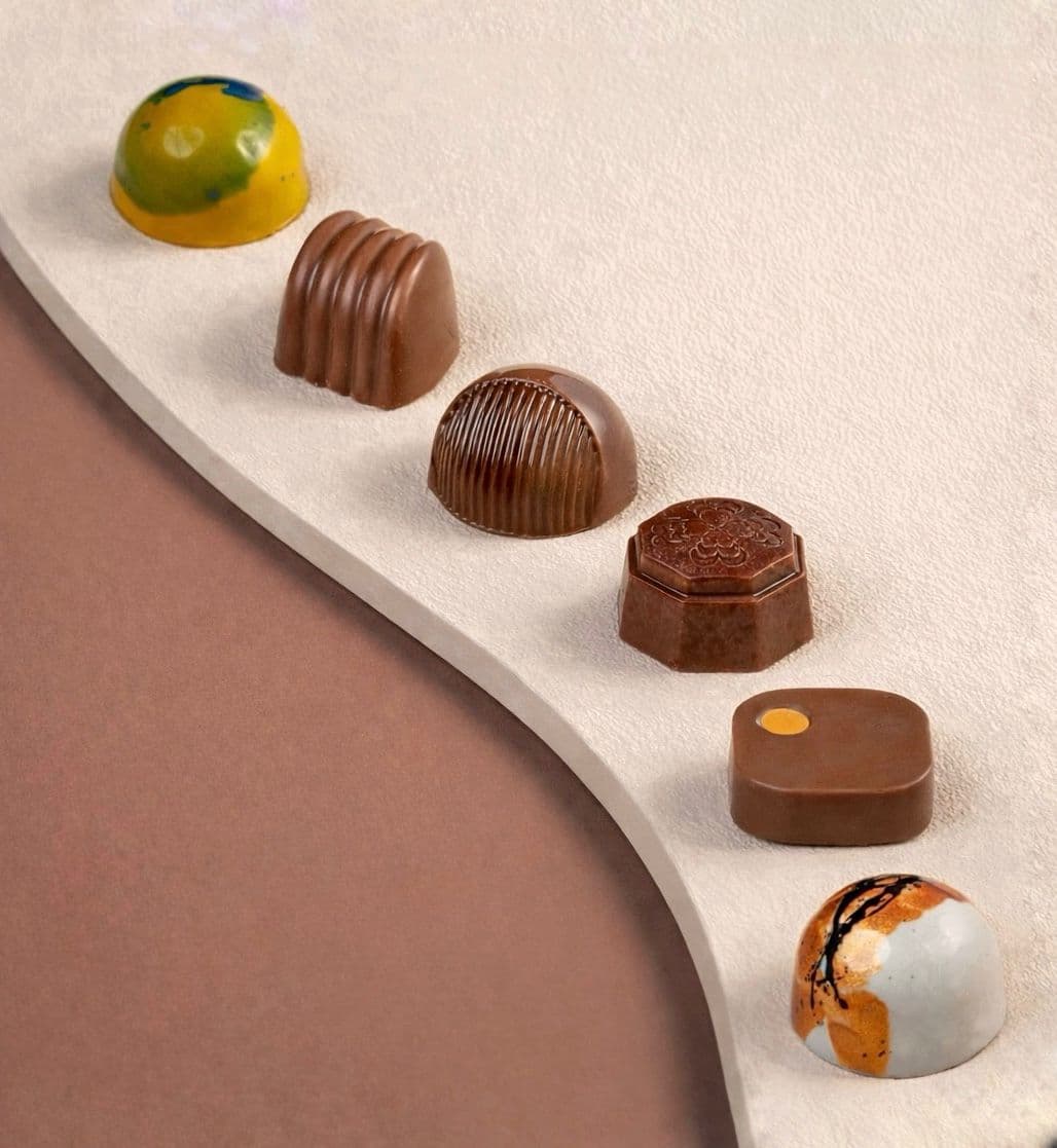 Artisan Benne pralines arranged on a marble surface